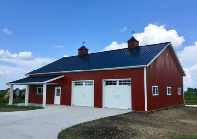 Residential home with a dark blue roof and two garage doors.