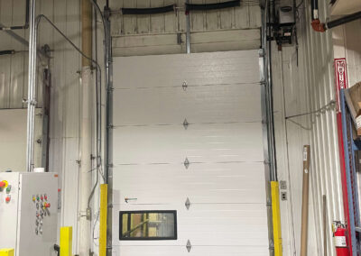 Conti-Tech - A white garage door in a warehouse.
