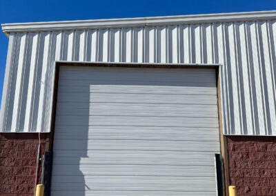FedEx - A metal garage door with a blue sky behind it.