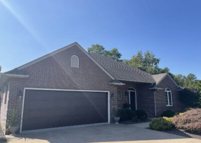 A brick home with a garage and driveway.