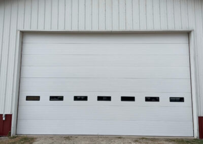 A white garage door with two windows.