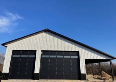 A black and white garage with two garage doors.