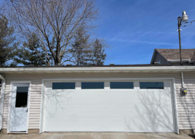 A white garage door with a window in it.