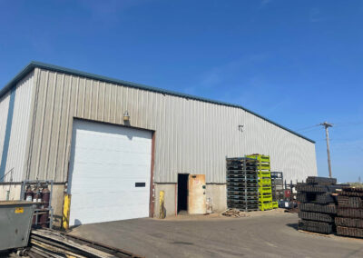 A warehouse with a lot of pallets in it.