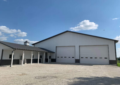 A white warehourse with two garage doors.