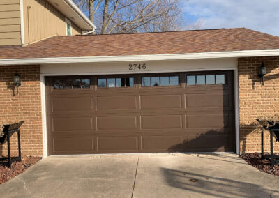 Martin - brown garage door in front of a house.