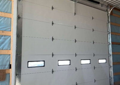 MELLINGER - garage door that is being installed in a building.