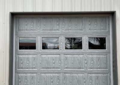 Peterson - a gray garage door with a metal frame.