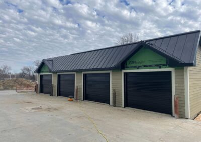 A garage with a black roof and black doors.