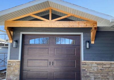 A house with a wooden garage door.