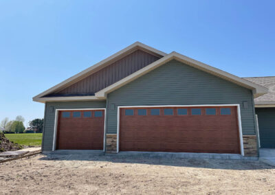 A home with a brown garage door and brown siding.