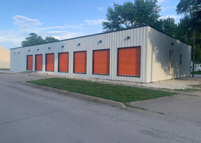 A storage building with orange shutters on the side.